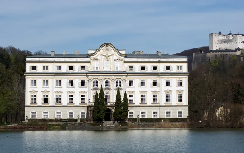 Schloss Leopoldskron reflected in its lake, Hohensalzburg Fortress beyond